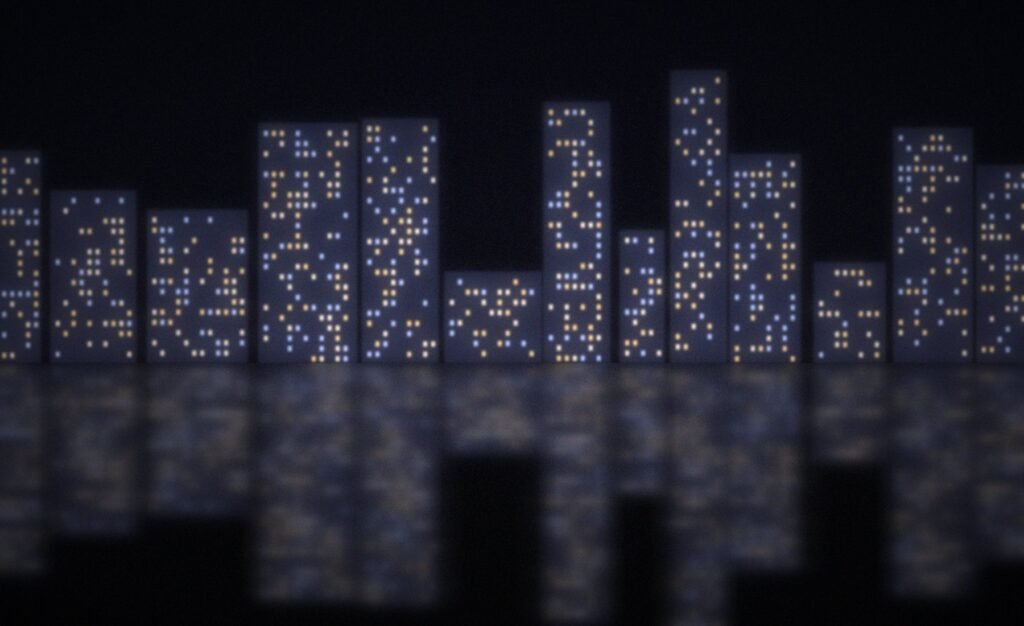 City towers reflected on a wet road at night