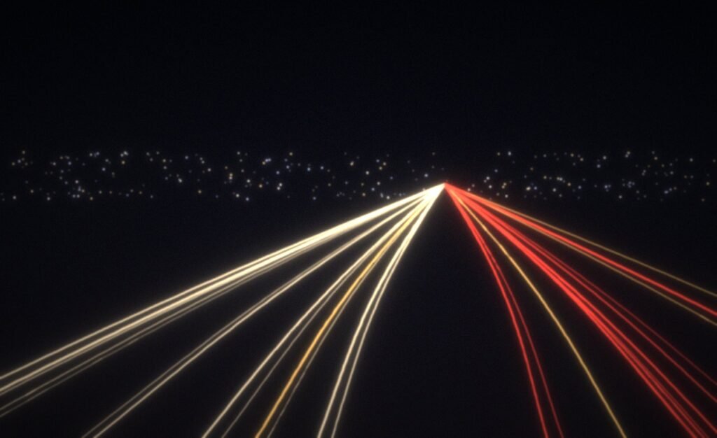 Long-exposure headlight trails on a night motorway
