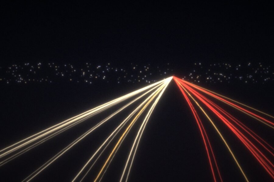 Long-exposure headlight trails on a night motorway