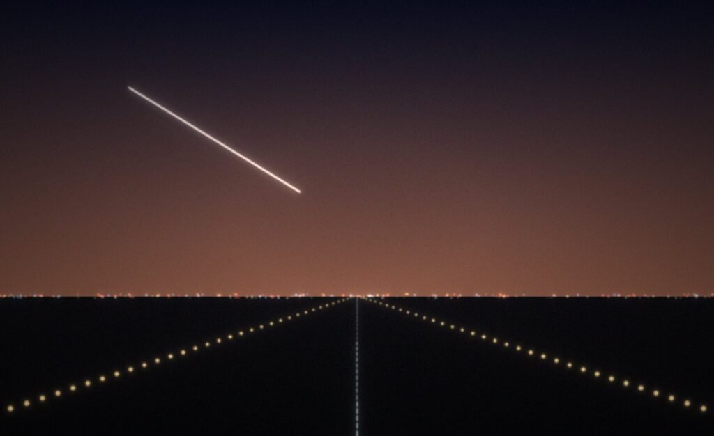 Runway lights at dusk with an aircraft on approach