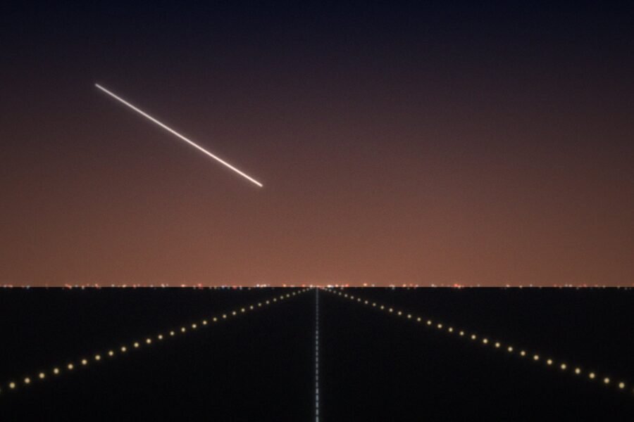 Runway lights at dusk with an aircraft on approach